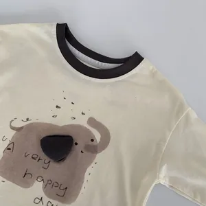 Detail of child long-sleeved t-shirt with brown ribbed neckline and elephant print