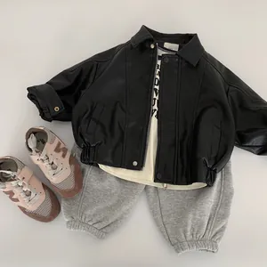 Kids black faux leather biker jacket paired with beige shirt and grey jogger pants