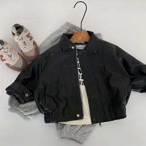 Detailed flat lay of children's black faux leather biker jacket with zipper and collar