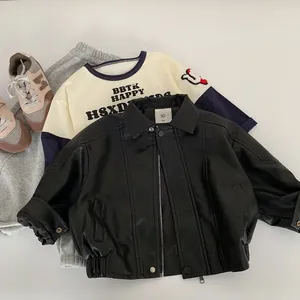 Detailed flat lay of children's black biker jacket, two-tone t-shirt, and grey joggers