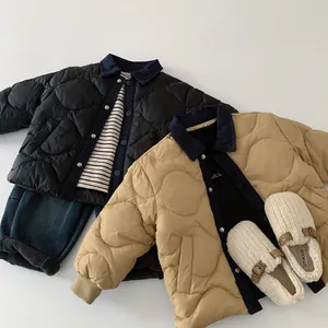 Detailed flat lay of quilted kids jackets in black and khaki with corduroy collars