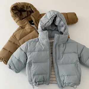 Detail of children's hooded down jackets in caramel brown and grey blue colors
