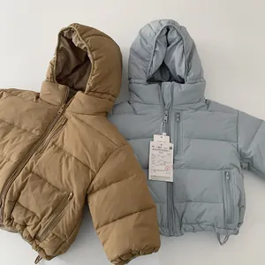 Detail of hooded kids puffer jackets with zipper pockets in coffee and blue colors