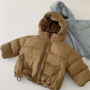 Detailed close-up of quilted hooded puffer jacket with three functional zipper pockets