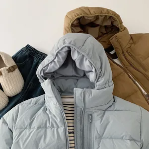 Flat lay of kids 90% white duck down winter jackets and fleece shoes outfit set