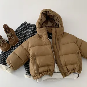 Detailed flat lay of children's brown hooded down jacket with zipper pockets and boots