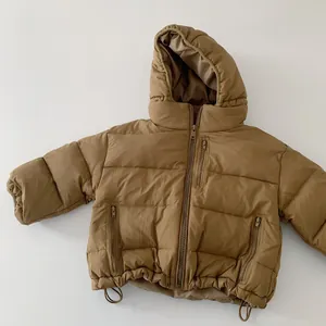 Close-up of children's down jacket featuring front zipper and three functional zip pockets