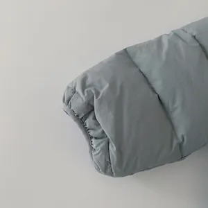 Detail of windproof elastic cuff on a 90 white duck down winter puffer jacket for kids