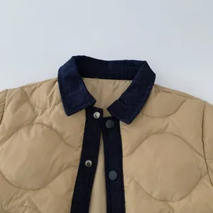 Detail of boys' wave-quilted jacket with khaki fabric and navy denim collar stitching