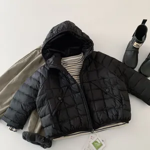 Flat lay of kids waterproof black quilted down jacket with Teflon functional hangtag