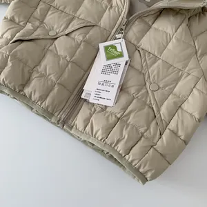 Detail of light khaki quilted down jacket featuring Teflon fabric protection and pockets