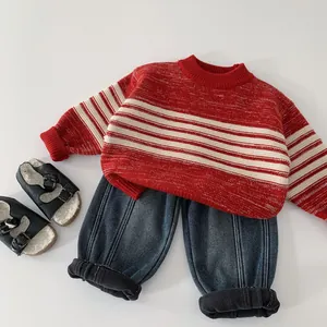 Toddler red and white striped knit sweater paired with dark blue jeans and black shoes