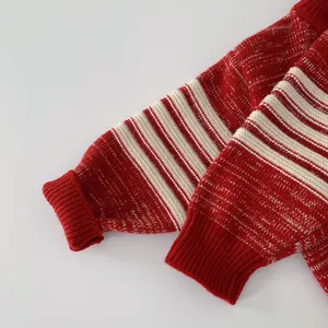Close-up of red and white striped knit fabric with ribbed cuffs on a children sweater