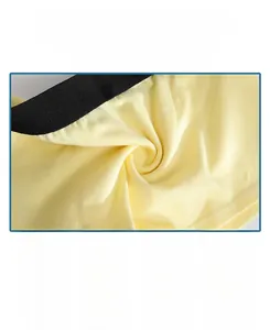 Close-up of soft yellow combed cotton fabric with elastic black waistband detail