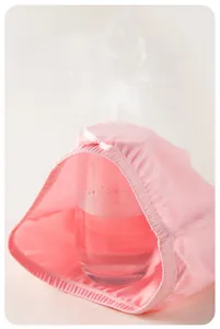 Pink cotton girls' leggings showing high breathability with steam passing through the fabric
