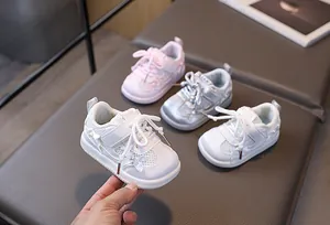 Detail view of infant sneakers featuring breathable mesh and cute pearl bow decorations