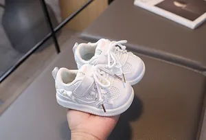 Detail of baby walking shoe with breathable mesh, pearl accents and bow decoration