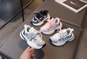 Detail showing toddler sneakers with mesh upper, Velcro strap, and thick durable sole