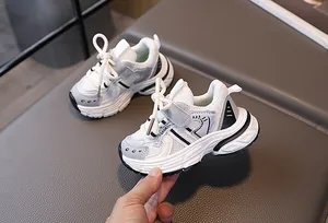 Close-up of kids breathable mesh sports sneakers with velcro strap and chunky sole