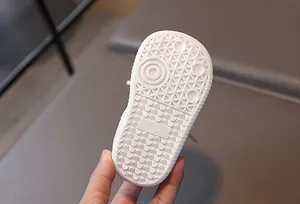 Close-up of the non-slip rubber sole with texture and size 18 markings for baby shoes