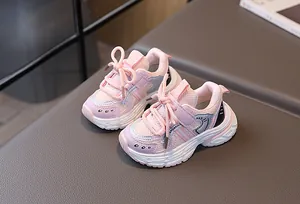 Detail of pink and purple kids sports shoes with mesh fabric and velcro strap
