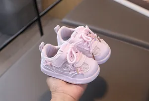 Close-up of pink baby mesh walking shoe featuring soft bow detail and velcro closure