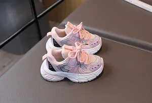Detail view of pink and purple breathable mesh kids sneaker with secure velcro strap