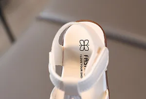 Detail view of toddler girl sandals featuring a soft inner sole with fashion logo and velcro strap