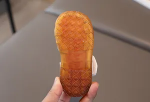 Close-up of non-slip translucent rubber sole with size engraving for toddler sandals