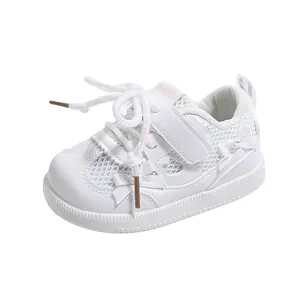 White toddler sneakers with mesh upper, Velcro strap, pearl and bow detail in a side view