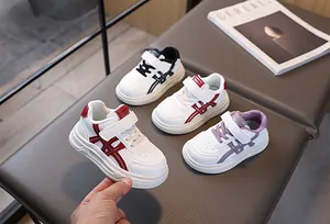 Detail of children's white sneakers with velcro strap and comfortable thick soles
