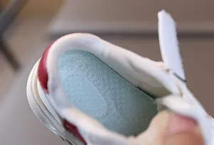Macro detail of breathable mesh insole and soft lining in kids white casual sneakers