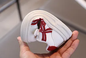 Detail shot of flexible soft rubber sole on white children sneakers showing high elasticity