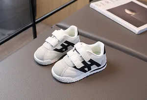 Detail of children's sneakers with double hook-and-loop straps and anti-slip rubber soles