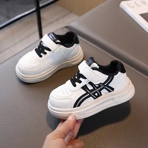 Classic black and white kids' sneakers with hook-and-loop strap and soft non-slip sole