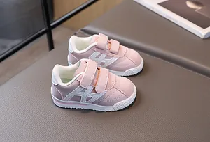 Macro detail of girls pink and white velcro sneakers with anti-slip rubber soles