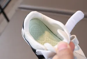 Macro view of breathable honeycomb insole and padded collar for kids' sneakers