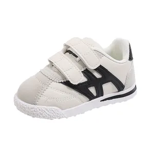 Kids off-white casual sneakers with black geometric stripes and double hook-and-loop straps