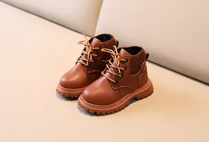 Macro shot of brown leather kids martin boots with knitted collar and anti-slip rubber sole