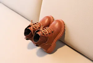 Close-up of brown children's Martin boots with knit cuff and non-slip thick rubber sole