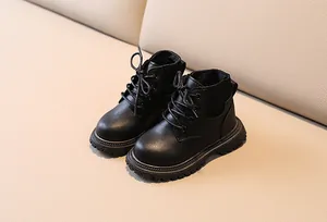 Detail of black leather kids' boots featuring knit collar and chunky anti-slip sole