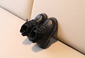 Detail of kids black leather martin boots with ribbed knit collar and non-slip thick sole
