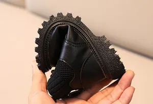 Detail showing the ultra-flexible rubber sole and soft black leather of children's boots