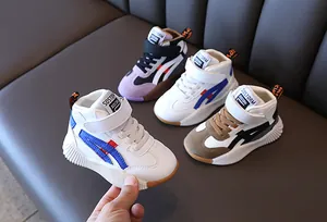 Close-up of kids' mid-top sneakers showing non-slip rubber soles and velcro straps