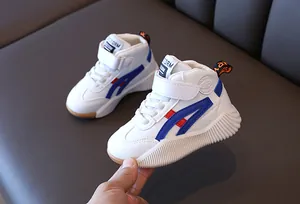 Close-up of kids mid-top sneakers with velcro straps and anti-slip thick rubber soles