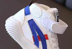 Detailed close-up of kids' high-top sneaker showing velcro straps and non-slip sole texture