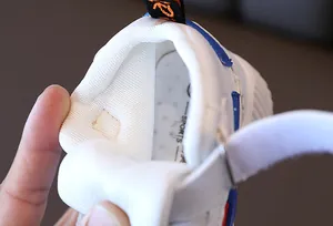 Detailed macro view of breathable honeycomb mesh lining and velcro closure on kids sneakers