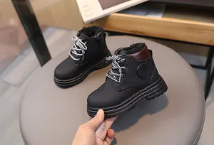 Detail view of children's black snow boot featuring thick fleece lining and side zipper