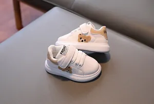 Detail of toddler sneakers with cute 3D plush bear patch and easy velcro closure