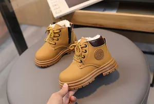 Detailed side view of yellow kids snow boots showing warm white fleece lining and zipper